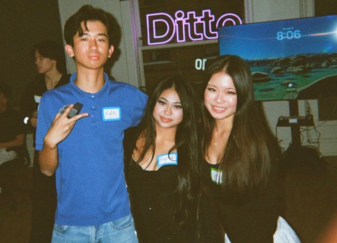 At a Ditto event, under the neon sign